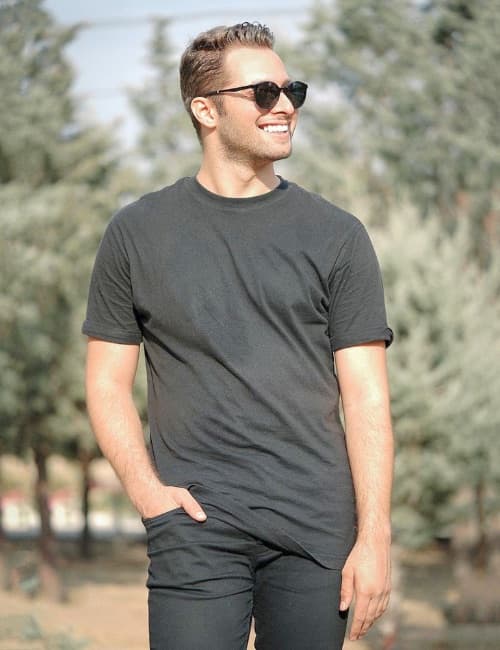 A man outdoors in a plain heavyweight dark t-shirt